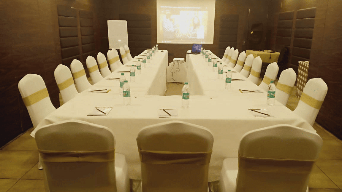 Back view of a u-shaped table with chairs at Calux Grand Baga.
